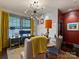 A well-appointed office space featuring a modern light fixture, desk, and comfortable seating options at 1413 Devon Dr, Charlotte, NC 28209