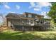The backyard features a deck, lattice, and a lush lawn at 15324 Yarmouth Rd, Mint Hill, NC 28227