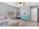Cozy bedroom with large window, light walls, and a blue dresser at 15324 Yarmouth Rd, Mint Hill, NC 28227