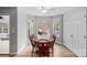 Cozy dining room featuring wood table set, natural light, and neutral paint, with hardwood floors at 15324 Yarmouth Rd, Mint Hill, NC 28227