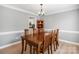 Traditional dining room features wood table, neutral walls, and elegant lighting for gatherings at 15324 Yarmouth Rd, Mint Hill, NC 28227