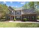 Two-story brick and siding home featuring a well-maintained lawn and walkway leading to the front door at 15324 Yarmouth Rd, Mint Hill, NC 28227