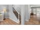 Well-lit hallway with wood floors, leading to staircase and french doors that offer versatile space at 15324 Yarmouth Rd, Mint Hill, NC 28227