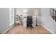 Bright home office with wood floors, featuring a functional desk setup and ample natural light at 15324 Yarmouth Rd, Mint Hill, NC 28227