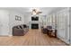 Inviting living room with fireplace, wood floors and plenty of sunlight, creating a warm and comfortable atmosphere at 15324 Yarmouth Rd, Mint Hill, NC 28227