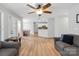 Open-concept living area with wood floors, seamlessly connecting to the dining area and kitchen for easy entertaining at 15324 Yarmouth Rd, Mint Hill, NC 28227