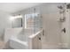 A large tub and glass shower are well lit by the window in the primary bathroom at 15324 Yarmouth Rd, Mint Hill, NC 28227