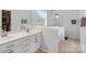 Bright bathroom featuring double sinks, tile flooring, a glass shower, and a large soaking tub at 15324 Yarmouth Rd, Mint Hill, NC 28227