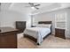 Spacious main bedroom with a tray ceiling, ceiling fan, and complete furniture set at 15324 Yarmouth Rd, Mint Hill, NC 28227