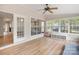 Sunroom offers lots of natural light, ceiling fan and ample windows, with light hardwood floors at 15324 Yarmouth Rd, Mint Hill, NC 28227