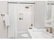 Clean and modern bathroom featuring a shower-tub, recessed shelf, and a rainfall shower head at 1534 Easy St, Belmont, NC 28012