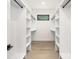 Bright walk-in closet with custom shelving and a natural light-filled window at 1534 Easy St, Belmont, NC 28012