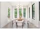 Bright dining area with modern light fixture, views of the backyard and patio access at 1534 Easy St, Belmont, NC 28012