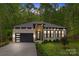 Charming brick home featuring a modern garage, landscaped yard, and inviting entryway at 1534 Easy St, Belmont, NC 28012