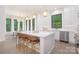 Bright, modern kitchen with white cabinetry, stainless steel appliances, and a large center island at 1534 Easy St, Belmont, NC 28012