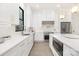 Bright kitchen features white cabinets, stainless steel appliances, and a spacious quartz countertop island at 1534 Easy St, Belmont, NC 28012