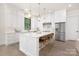 Modern kitchen featuring white cabinets, a large island with seating, and stainless steel appliances at 1534 Easy St, Belmont, NC 28012
