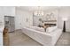 Open living space with a large sofa, fireplace, and view into the bright kitchen area at 1534 Easy St, Belmont, NC 28012
