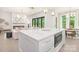 Open concept living room, seamlessly connecting the kitchen with fireplace, modern lighting, and backyard access at 1534 Easy St, Belmont, NC 28012