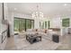 Bright living room featuring a fireplace, modern lighting, and access to the outdoor deck at 1534 Easy St, Belmont, NC 28012