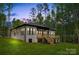 Back of brick home featuring a wooden deck with stairs, and a well-kept lawn at 1534 Easy St, Belmont, NC 28012