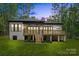 Back of brick home featuring a wooden deck with stairs, and a well-kept lawn at 1534 Easy St, Belmont, NC 28012