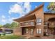 Unique two-story condo with wood exterior, a covered porch, and ample parking space at 1832 J Julian Ln, Charlotte, NC 28208