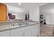 The kitchen area has double sinks, dishwasher and view of the living area at 1832 J Julian Ln, Charlotte, NC 28208
