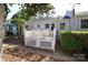 Cozy backyard with a white-painted brick home and charming lattice-enclosed deck at 1904 Lynnwood Dr, Charlotte, NC 28209