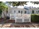 Charming home with a white brick exterior, a backyard deck and a green landscaped yard at 1904 Lynnwood Dr, Charlotte, NC 28209