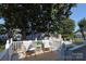 Charming deck with outdoor seating nestled under a mature tree canopy at 1904 Lynnwood Dr, Charlotte, NC 28209