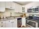 This kitchen has stainless steel appliances, granite countertops, white cabinets and a window at 1904 Lynnwood Dr, Charlotte, NC 28209