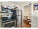 Bright kitchen featuring stainless appliances, a wine rack, and eat in breakfast table at 1904 Lynnwood Dr, Charlotte, NC 28209