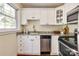 Galley kitchen featuring granite countertops, stainless steel appliances, white cabinets, and a window at 1904 Lynnwood Dr, Charlotte, NC 28209