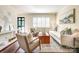 Cozy living room featuring hardwood floors, neutral decor, plantation shutters, and comfortable seating at 1904 Lynnwood Dr, Charlotte, NC 28209