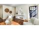 Warm living room featuring hardwood floors, neutral decor, plantation shutters, and comfortable seating at 1904 Lynnwood Dr, Charlotte, NC 28209