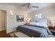 Comfortable bedroom features a ceiling fan, plush bedding, and two windows for natural light at 1904 Lynnwood Dr, Charlotte, NC 28209