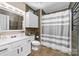 Bathroom featuring vanity with a medicine cabinet, toilet and shower with striped curtain at 1916 Pine Mountain Rd, Charlotte, NC 28214