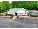 Community clubhouse with vibrant landscaping, parking, a pool and a playground at 1916 Pine Mountain Rd, Charlotte, NC 28214