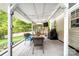 Outdoor covered patio with seating, lighting, and grill. Perfect for outdoor relaxation and cooking at 1916 Pine Mountain Rd, Charlotte, NC 28214