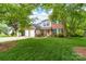 Charming two-story brick and siding home with a well-manicured lawn and a two-car garage at 1916 Pine Mountain Rd, Charlotte, NC 28214