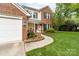 Charming two-story home with brick and light siding, plus a well-manicured front yard at 1916 Pine Mountain Rd, Charlotte, NC 28214