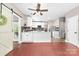 Bright kitchen featuring white cabinets, stainless steel appliances, and a sliding barn door at 1916 Pine Mountain Rd, Charlotte, NC 28214
