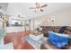 Open-concept living room with hardwood floors, fireplace, and a view of the modern kitchen at 1916 Pine Mountain Rd, Charlotte, NC 28214