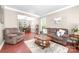 Cozy living room with wood floors, a large sectional sofa, a decorative rug, and views to the dining area at 1916 Pine Mountain Rd, Charlotte, NC 28214