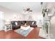 Comfortable living room with hardwood floors, fireplace, and a large leather sectional sofa at 1916 Pine Mountain Rd, Charlotte, NC 28214