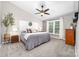 Serene main bedroom with a ceiling fan, a comfortable bed, side tables, and a large window at 1916 Pine Mountain Rd, Charlotte, NC 28214