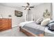 Cozy main bedroom featuring a ceiling fan, a comfortable bed, and a wooden dresser for ample storage at 1916 Pine Mountain Rd, Charlotte, NC 28214
