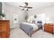 Serene main bedroom with a ceiling fan, a comfortable bed, side tables, and access to the main bathroom at 1916 Pine Mountain Rd, Charlotte, NC 28214