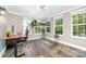 Bright office space featuring stone floors, many windows, modern lighting, and a stylish desk with a large monitor at 1916 Pine Mountain Rd, Charlotte, NC 28214